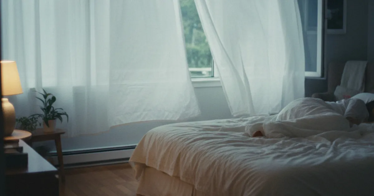 Person sleeping peacefully in a dark, calm bedroom representing sleep recovery after quitting alcohol